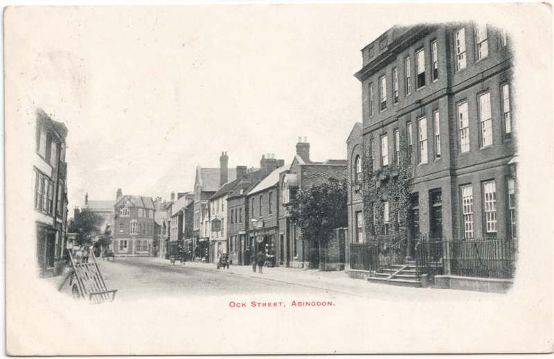The front of an old postcard. The postcard is of Abingdon: Town Centre Streets