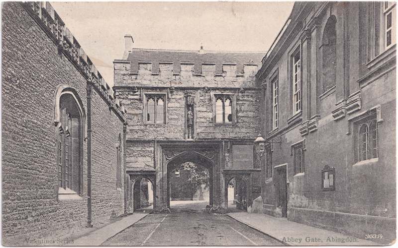 The front of an old postcard. The postcard is of Abingdon: Abbey Gateway