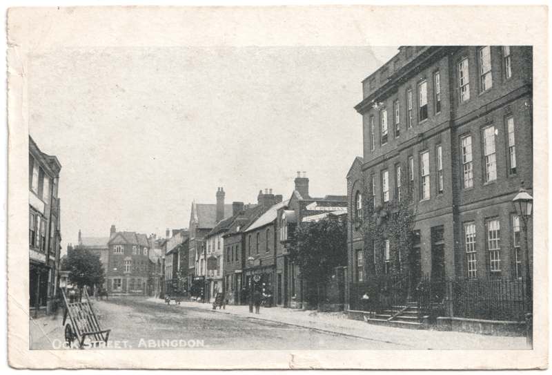 The front of an old postcard. The postcard is of Abingdon: Town Centre Streets