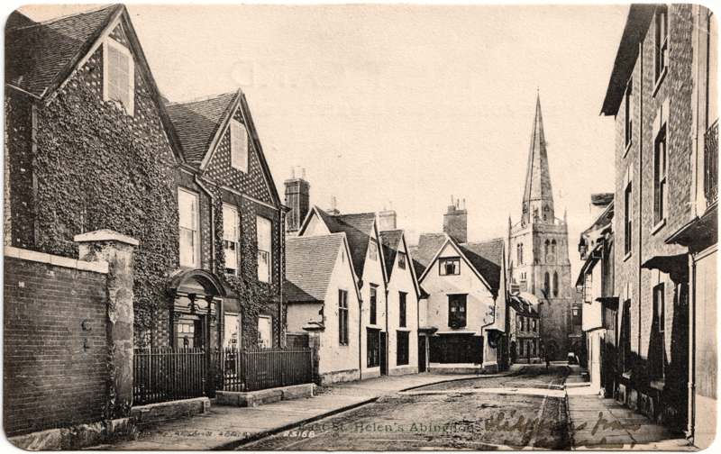 The front of an old postcard. The postcard is of Abingdon: Town Centre Streets