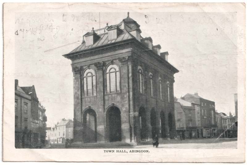 The front of an old postcard. The postcard is of Abingdon: Marketplace