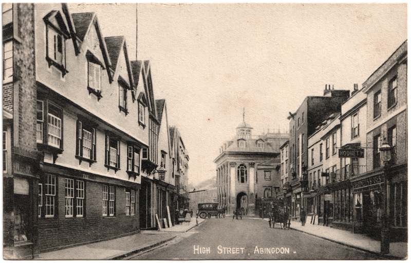 The front of an old postcard. The postcard is of Abingdon: Town Centre Streets