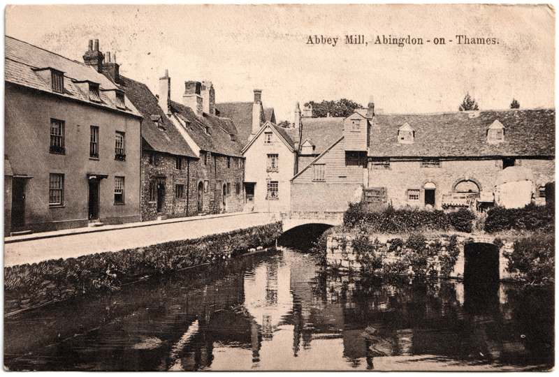 The front of an old postcard. The postcard is of Abingdon: The Abbey Buildings
