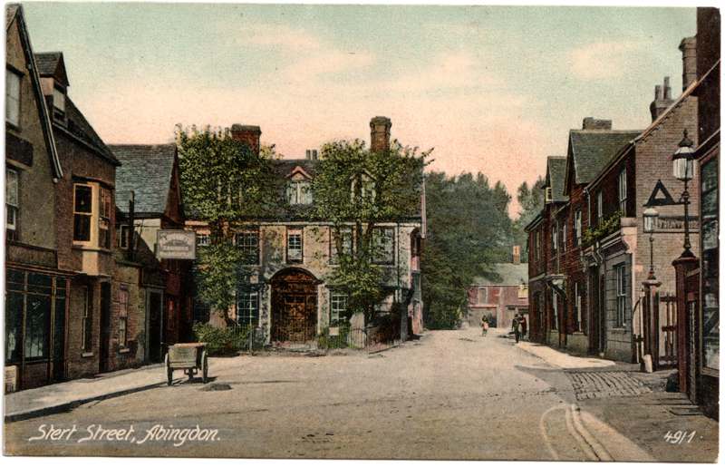 The front of an old postcard. The postcard is of Abingdon: Town Centre Streets