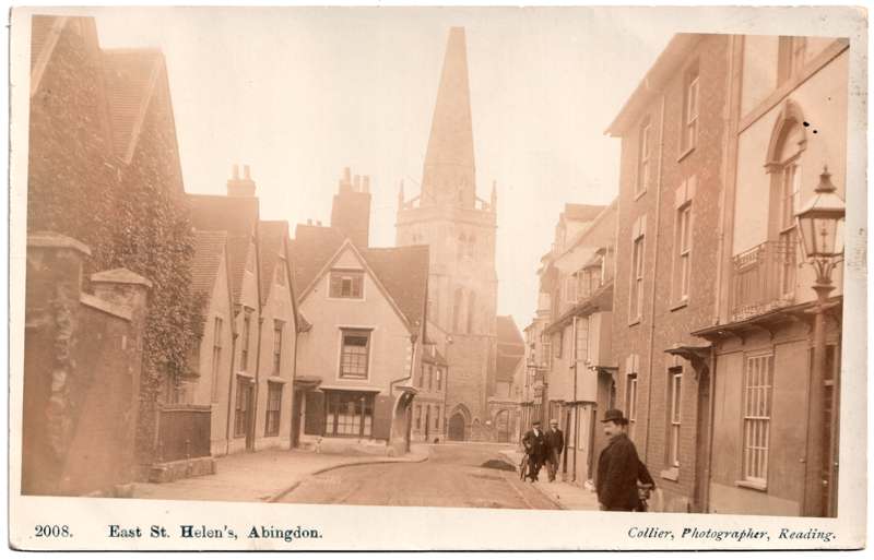The front of an old postcard. The postcard is of Abingdon: Town Centre Streets