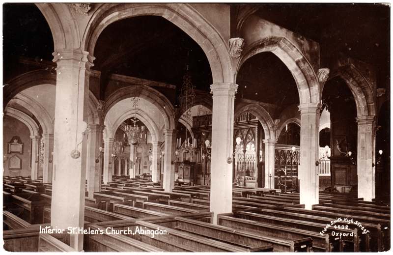 The front of an old postcard. The postcard is of Abingdon: St. Helen's Church and the Almshouses