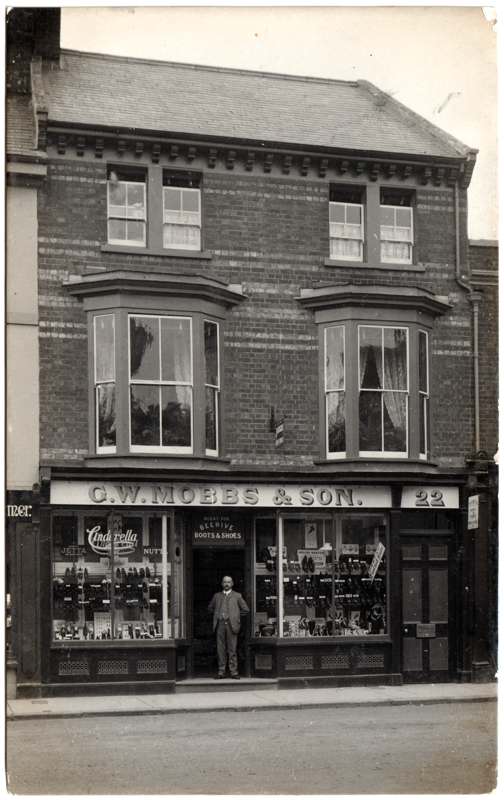 The front of an old postcard. The postcard is of Abingdon: Town Centre Streets