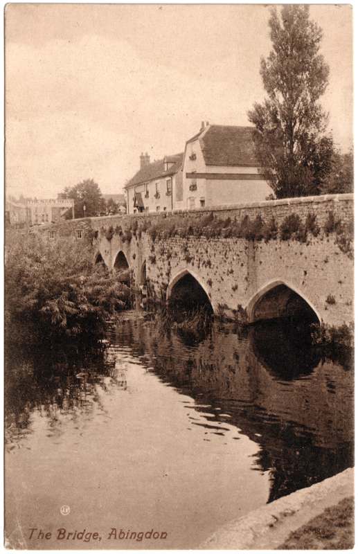 The front of an old postcard. The postcard is of Abingdon: The Bridge