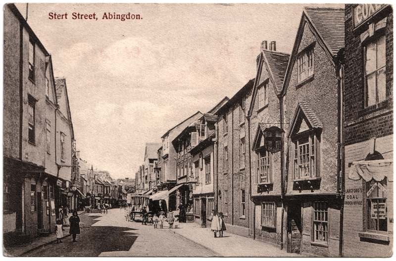 The front of an old postcard. The postcard is of Abingdon: Town Centre Streets