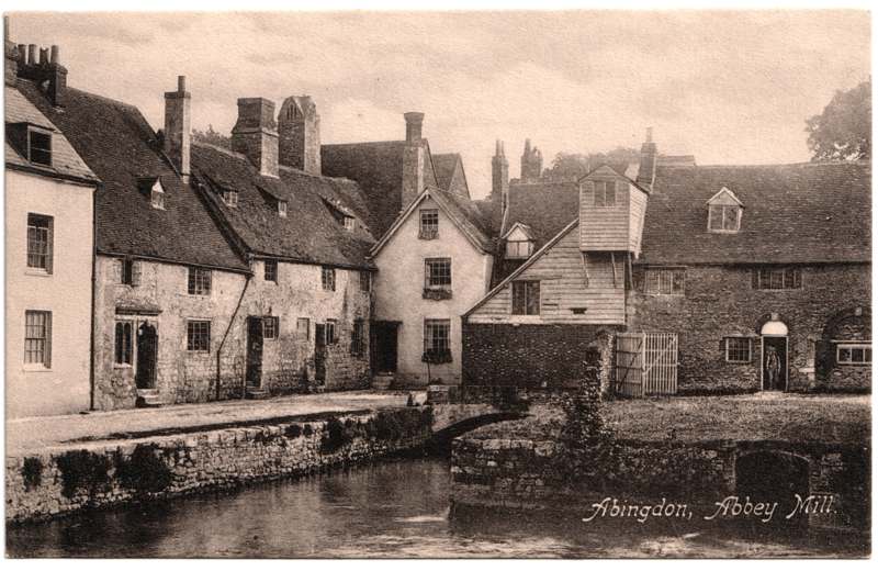 The front of an old postcard. The postcard is of Abingdon: Town Centre Streets