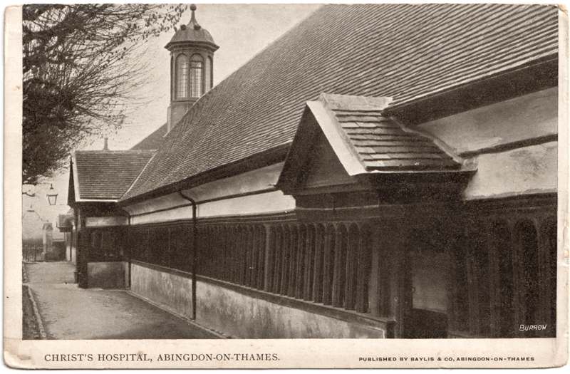 The front of an old postcard. The postcard is of Abingdon: St. Helen's Church and the Almshouses