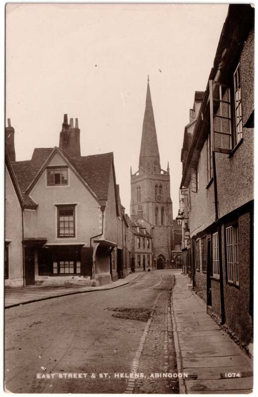 The front of an old postcard. The postcard is of Abingdon: Town Centre Streets