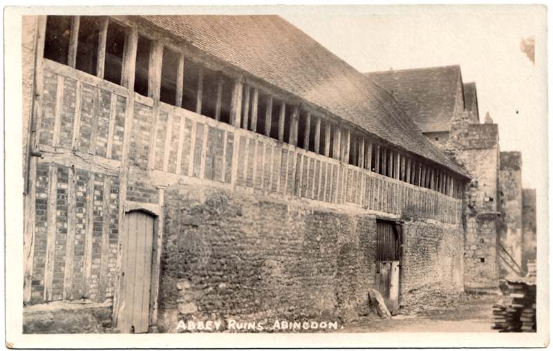 The front of an old postcard. The postcard is of Abingdon: The Abbey Buildings