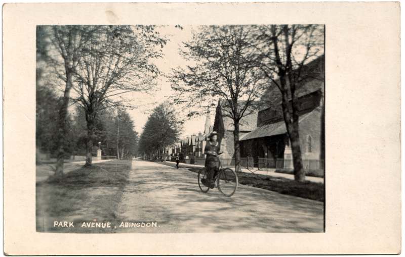 The front of an old postcard. The postcard is of Abingdon: Albert Park and Abingdon School