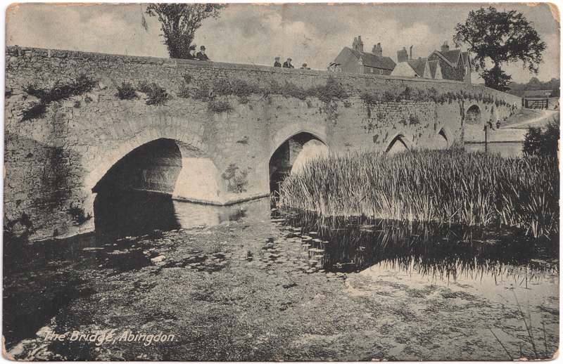 The front of an old postcard. The postcard is of Abingdon: The Bridge