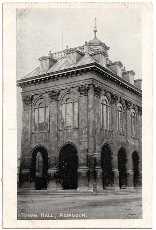 The front of an old postcard. The postcard is of Abingdon: Marketplace