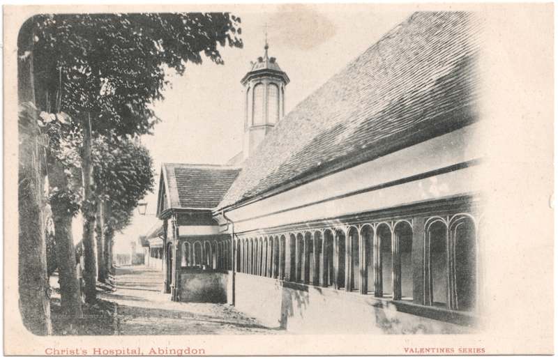 The front of an old postcard. The postcard is of Abingdon: St. Helen's Church and the Almshouses