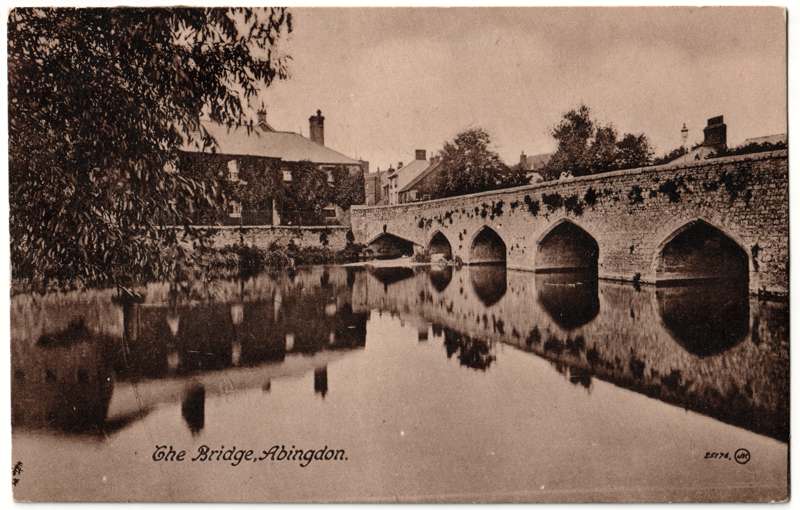 The front of an old postcard. The postcard is of Abingdon: The Bridge